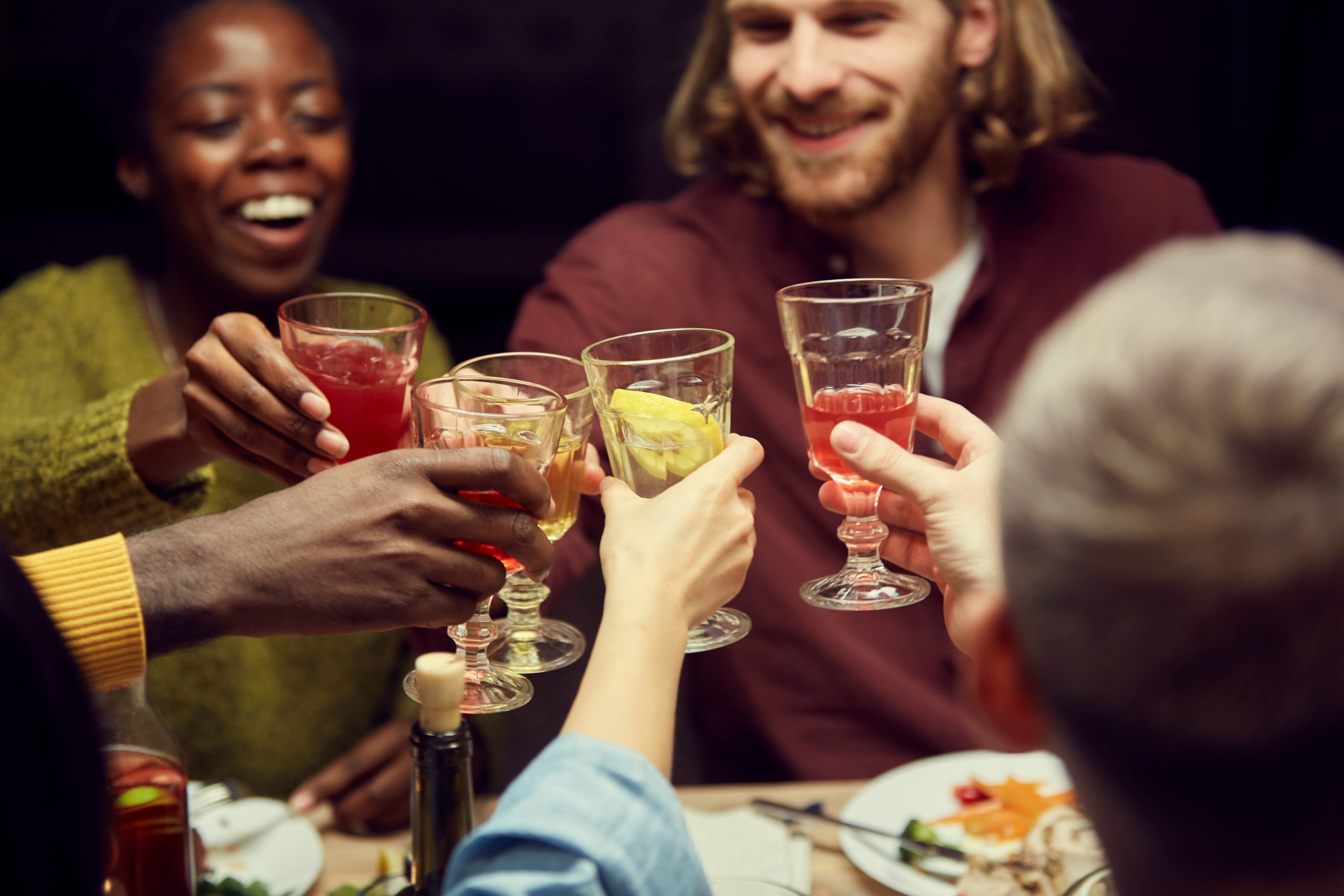 Guests Clinking Glasses at Dinner Party