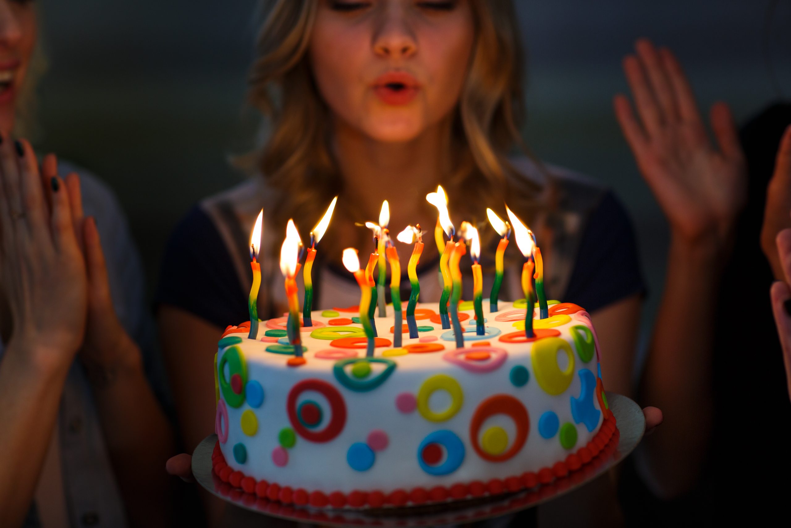 Birthday. Girls with a cake with candles.